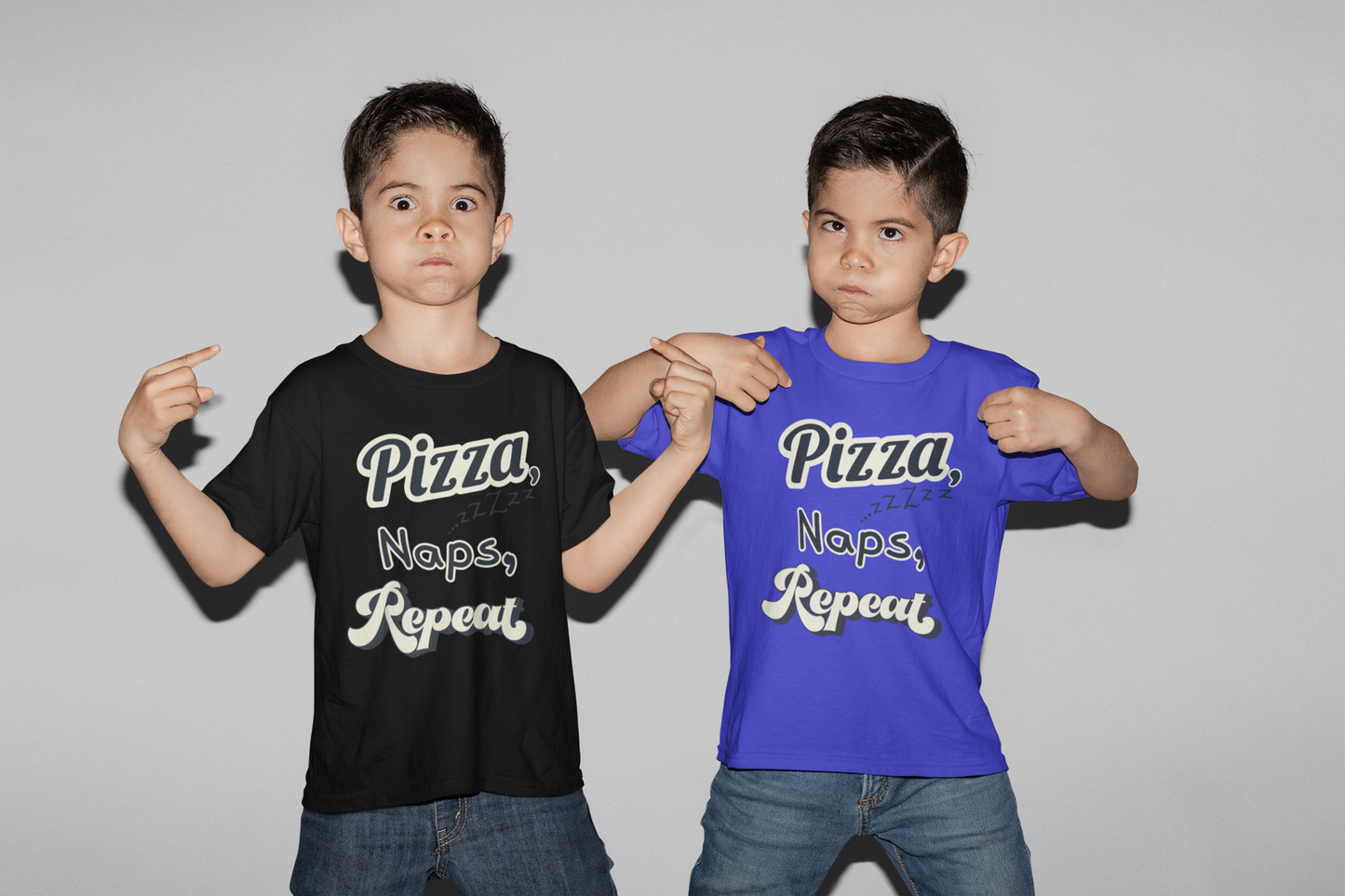 Two children wearing t-shirts with 'Pizza Naps Repeat' text on a plain background